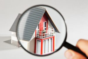 A model house viewed through a magnifying glass